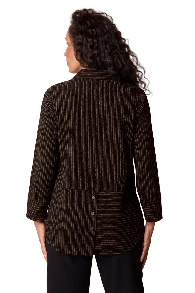 Woman wearing a brown textured jacket against a beige background